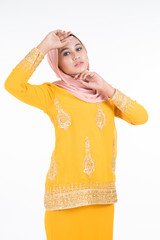 Obraz premium Beautiful female Muslim model in modern kurung and hijab, a modern lifestyle apparel for Muslim women isolated on white background. Beauty and hijab fashion concept. Full length portrait