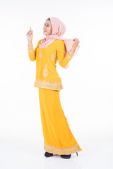 Beautiful female Muslim model in modern kurung and hijab, a modern lifestyle apparel for Muslim women isolated on white background. Beauty and hijab fashion concept. Full length portrait