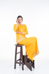 Fototapeta na wymiar Beautiful female Asian model in various poses wearing modern kurung, a Malaysian traditional wear isolated on white background. Beauty and fashion concept. Full length portrait