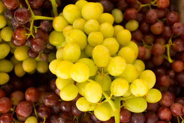 A lot of bunch of red and green grapes