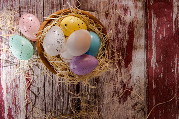 Easter eggs in a nest on a textured background