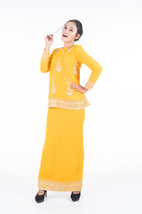 Beautiful female Asian model in various poses wearing modern kurung, a Malaysian traditional wear isolated on white background. Beauty and fashion concept. Full length portrait