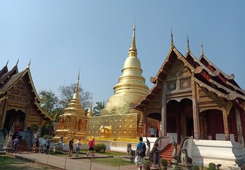 Naklejka premium Golden Chedi, Wat Phra Singh, is a tourist attraction of Chiang Mai, Thailand with many tourists.