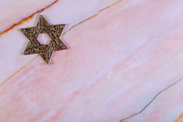 Jewish symbol star of David on granite background.