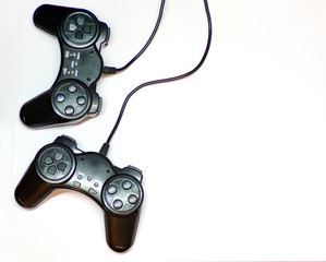Video game joysticks are isolated on a white background top view with copy space. The controller with the USB wire. Joystick for game console and personal computer.