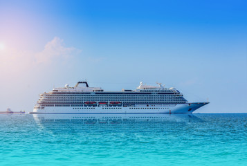 Cruise ship sailing in the sea, large luxury white cruise ship liner on blue sea water and blue sky...