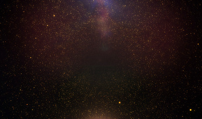 Abstract retro 1920 style vintage background of flickering gold tone particles and light flare