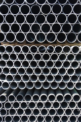 Close-up front view of stacks of plastic water pipes 