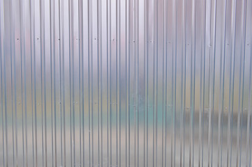 Silver tin iron wall with vertical and diagonal stripes from a metal profile of a metal sheet....