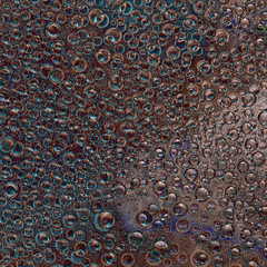Pattern of randomly interwoven rings  and balls of different diameters and turquoise and bronze...