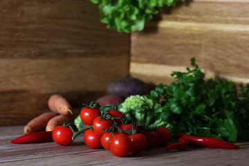 fresh colored vegetables for cooking laid out on a wooden background