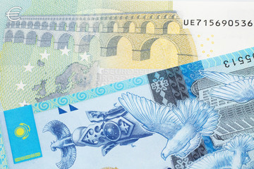 A five Euro note from the European Union eurozone paired with a blue, five hundred tenge bank note from Kazakhstan