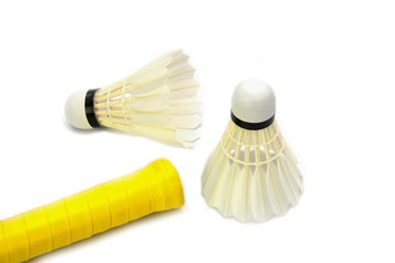 Fototapeta na wymiar Two brand new shuttlecocks and yellow handle Badminton racket isolated on white background