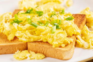 Delicious breakfast of scrambled eggs and toast with copy space