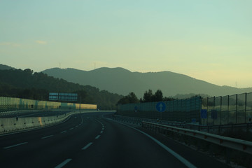 Fototapeta na wymiar highway in the mountains at the sunset