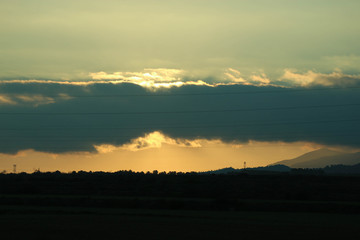 sunset over the mountains with clouds