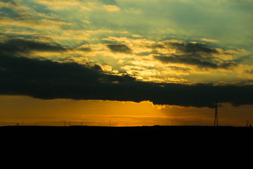 orange sunset over the hills with clouds