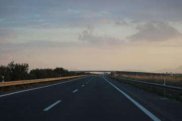 Fototapeta premium driving on highway into the sunset