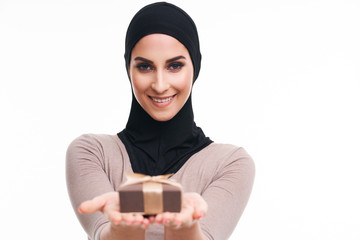 Muslim woman with present over white background