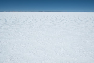 Flat and white surface of the Salar de Uyuni salt flat, Bolivia