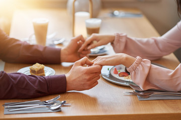 Young Couple Enjoying Coffee And Cake In Cafe