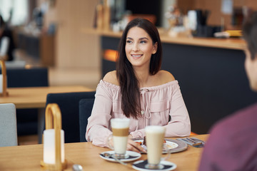 Young Couple Enjoying Coffee And Cake In Cafe