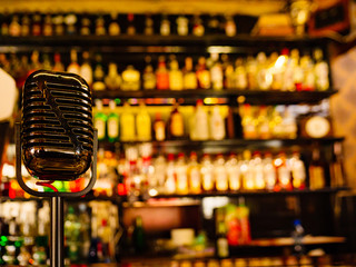 Bar counter and blurred background with alcohol bottles.