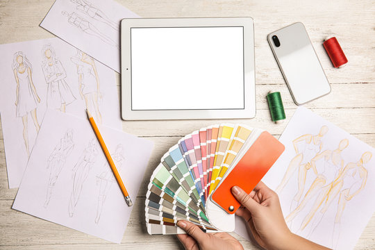 Fashion designer with color palette at workplace, top view