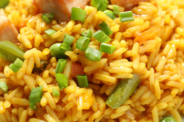 Delicious rice pilaf with vegetables as background, closeup