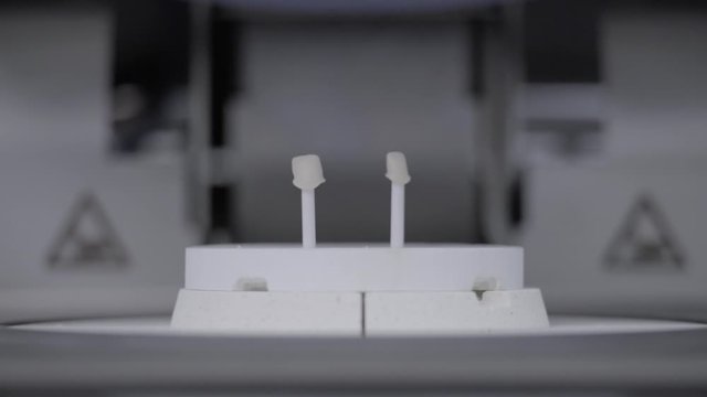 Artificial teeth in extremely high temperature oven in dental clinic. Dental technician bakes ceramic teeth in special furnace machine. Teeth reconstruction process in dental laboratory by technician