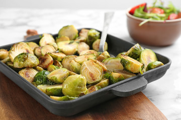 Delicious roasted brussels sprouts in baking dish, closeup