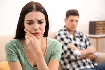 Unhappy woman after quarrel with her boyfriend at home. Relationship problems