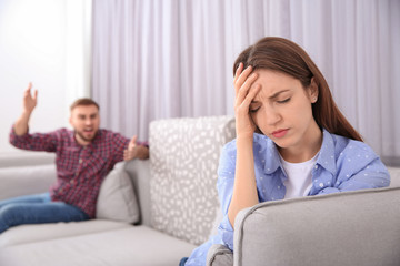 Unhappy woman after quarrel with her boyfriend at home. Relationship problems