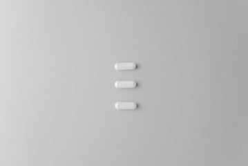 Scattered  white oval pills for health. Concept of healthy lifestyle, vitamins taking.