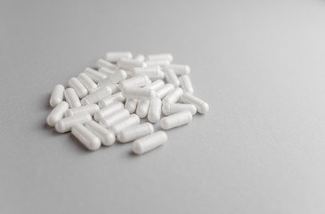 Scattered  white oval pills for health. Concept of healthy lifestyle, vitamins taking.