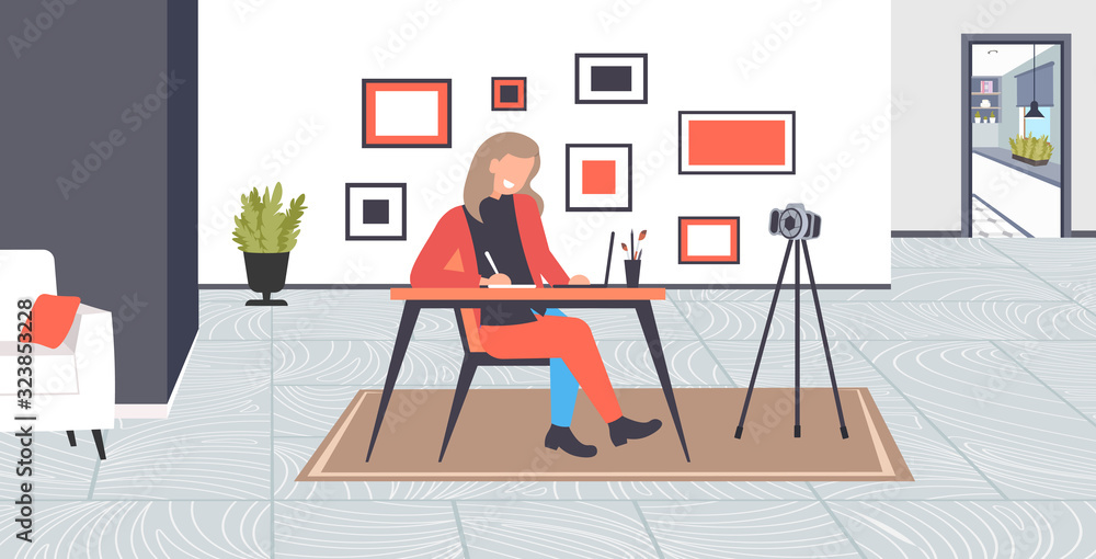 Poster student blogger using laptop doing homework recording online video with camera on tripod blogging li