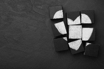 Heart drawn on black cubes, flat lay with space for text. Composition symbolizing problems in...
