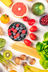 Vegan food, healthy diet flat lay. Fruits, vegetables, legumes, mushrooms, pasta, shot from the top on a white background