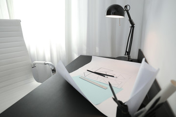 Stylish workplace with modern lamp and stationery
