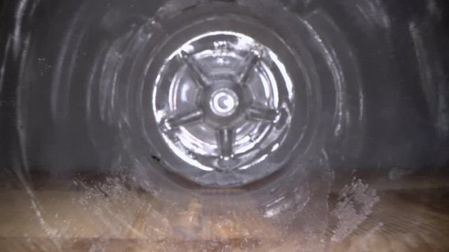 Inside the plastic bottle. Dolly macro shot of camera zooming in empty water bottle on wooden background