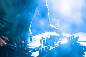 Dj mixes the track in the nightclub at a party, Christmas, new year