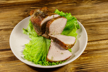 Tasty baked pork with spices on a wooden table