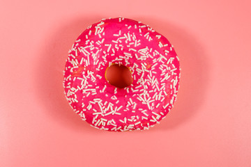 Tasty pink donut on pink background