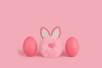 Pink easter fluffy bunny and two pink eggs on a pink background. Cute Pom-pom rabbit with heart shaped nose between two painted pink eggs. Happy Easter Concept. Copy space, place for text.