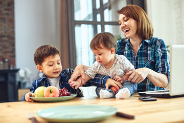 Fototapeta premium Happy international family concept. Dad, mom, son and little daughter posing for a camera at home, are engaged in home parenting. Home holidays, parenting, concept children and parents.