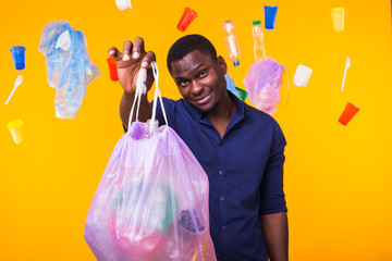 Problem of trash, plastic recycling, pollution and environmental concept - man holding garbage bag...