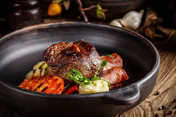 European cuisine in Ukrainian style. Beef steak with mashed potatoes and vegetables, with demiglas sauce. dishes in a restaurant in a clay plate. background image, copy space text