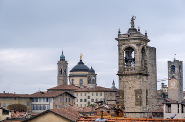 Fototapeta na wymiar Beautiful medieval bell towers at Old Bergamo city. Lombardy, Italy
