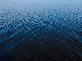 Blue lake with a wave, black and blue water, depth
