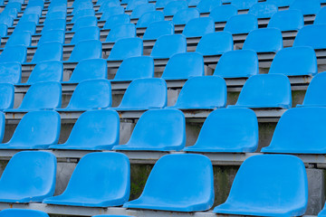 Seats in the stadium-background. auditorium-stands. Rows of chairs in an open-air stadium. Spectator seats.